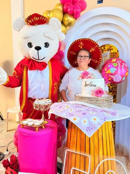 Osito mariachi sorpresa con arco de globos rosa y dorado y torta decorada para cumpleaños y quinceaños